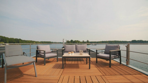 Espace lounge extérieur sur une maison flottante au Vakantiepark Leukermeer, Pays-Bas, vue sur le lac.