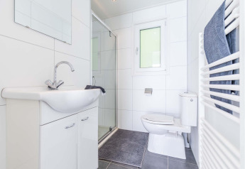 Modernes Bad in der Velthorst-Hütte im EuroParcs Parc du Soleil, Niederlande, mit Dusche und WC.