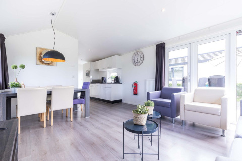 Luminoso y moderno salón y cocina en una cabaña Velthorst en EuroParcs Parc du Soleil, Países Bajos.