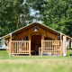 Safari tent Villatent Compact at Camping Betuwe in the Netherlands, surrounded by lush grass and trees.