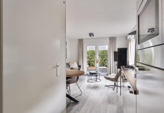 Modern two-person lodge at De Thijmse Berg, Netherlands, with cozy interior, kitchen, and garden access.