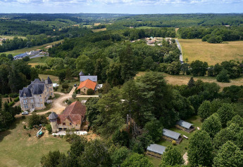 Aerial view of Camping Lestaubière, France, showing Villatent Wood safari tent, forest, and fields.