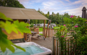 Safari telt ved Holiday Park Sallandshoeve i Holland med trædæk, boblebad og grønne omgivelser.