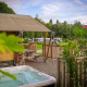 Safari Tent Wellness at Holiday Park Sallandshoeve in the Netherlands with hot tub and wooden deck.