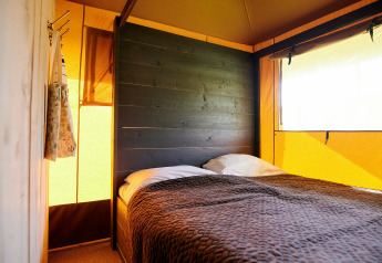 Camera da letto della tenda safari Safaricottage XL con letto matrimoniale al Holiday Park Sallandshoeve, Olanda.