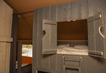 Vue intérieure de la tente Safaricottage XL avec lit cabine au Holiday Park Sallandshoeve, Pays-Bas.