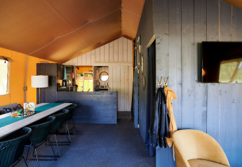 Interior view of a Safaricottage XL safari tent at Holiday Park Sallandshoeve in the Netherlands, modern decor.