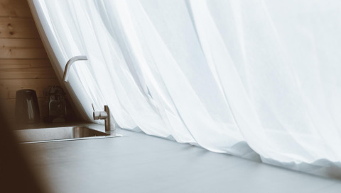 Moderne Spüle mit Wasserhahn und weißen Vorhängen im Big Oak Tent, Holiday Park Sallandshoeve, Niederlande.