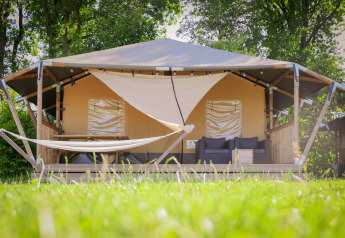 Safari cottage telt med veranda, hængekøje og udendørs siddepladser i Holiday Park Sallandshoeve, Holland.