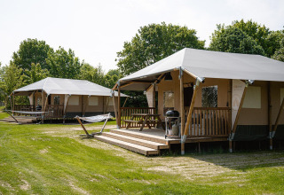 Deux tentes safari Villatent Cottage avec terrasse et barbecue au Camping Borken am See, entourées d’arbres.