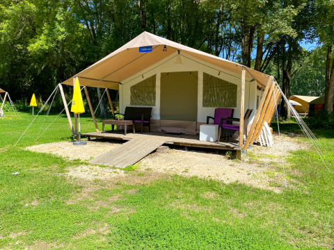 Tente safari Lodgetent St. Emilion Deluxe à La Draille en France, avec terrasse et mobilier de jardin.