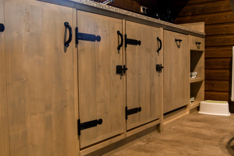 Houten kasten met zwarte handgrepen en sloten in River Lodge van Camping de Koeksebelt, Nederland.