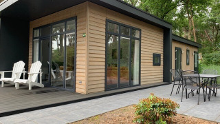 Modern Forest park chalet tiny house with patio seating at Holiday park De Kleine Belties, Netherlands.