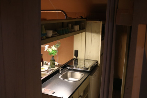A view of a cozy kitchen inside Safari cottage at Holiday park De Boshoek, Netherlands, featuring modern amenities.