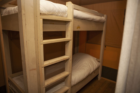 Bunk beds inside a safari tent at the Safari Cottage in Holiday park De Boshoek, Netherlands.