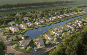 Aerial view of Water lodge 2 Deluxe with sauna and hot tub at Hofparken Wiltershaar, Netherlands, by water.