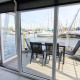 Woonboot Havenlodge N aan Marina Parcs Naarden in Nederland, zicht op jachthaven en boten vanaf het terras.