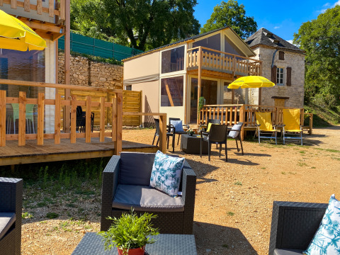 Outdoor seating and luxury safari lodge tent Belle Vue with yellow umbrellas at La Draille in France.