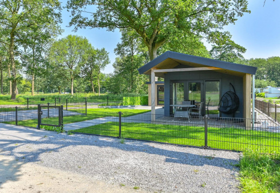 Lodge de luxe accessible aux fauteuils roulants à Drentse Weelde, Pays-Bas, entouré de verdure et arbres.