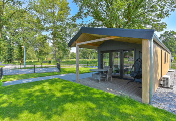 Udsigt til en luksuslodge med terrasse og have, handicapvenlig, på Drentse Weelde i Holland.