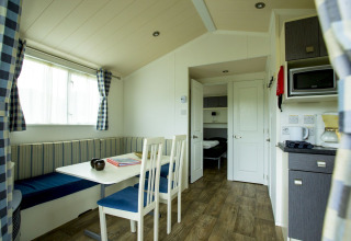 Vue intérieure d'une chaleureuse Delta Lodge au Holiday Park Duinhoeve aux Pays-Bas, avec équipements modernes.