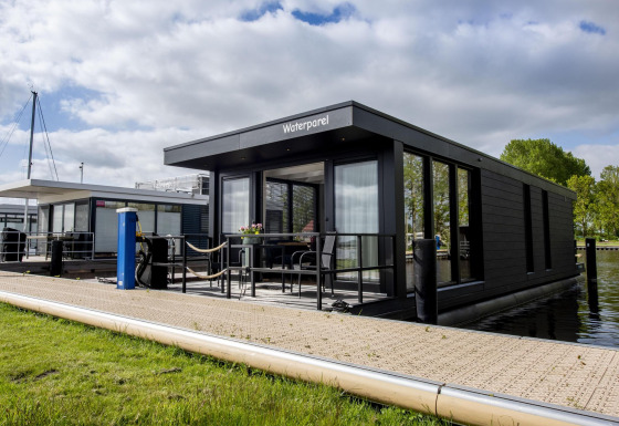 Moderne woonboot 'De Waterparel' bij Welcome In - Friesland, Nederland, aangemeerd aan het water.