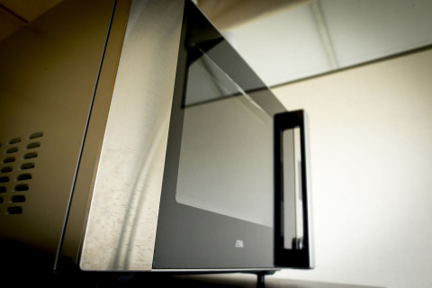 Close-up of a microwave oven inside the Tent Villa safari tent at Holiday Park Duinhoeve, Netherlands.