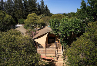 Tenda safari Villatent Nomad immersa nel verde al Camping Les Pêcheurs in Francia.