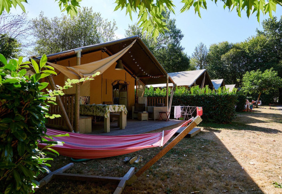 Safari-Zelt Villatent Nomad auf Camping Domaine du Logis in Frankreich mit Hängematte und Terrasse.