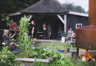 Gezinnen genieten van een gezellige barbecue bij Feather Down De Lange Weide in Drenthe, Nederland.