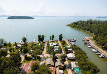 Vista aérea de la tienda safari Villatent Nomad en Camping Punta Navaccia junto al lago en Italia rodeada de naturaleza.