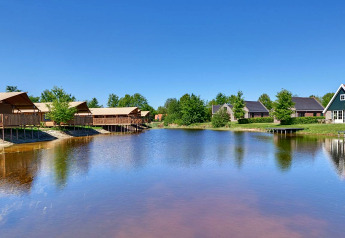 Safari tents and luxury glamping tents by a lake at Holiday park Eigen Wijze in the Netherlands.