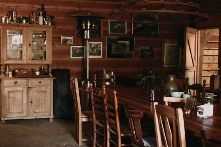 Cozy wooden cabin interior with rustic furniture at Feather Down Hoeve De Pippert, Gelderland, Netherlands.
