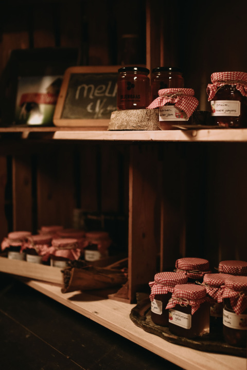 Hausgemachte Marmelade und Honig in Gläsern mit rotkarierten Deckeln im Feather Down Hoeve De Pippert.