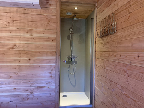 Dusche mit Holzwänden im Heydehuis + Jacuzzi Baumhaus bei Sandberghe in den Niederlanden.