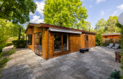 Exterior view of Veluwe lodge, a wooden tiny house at Bungalowpark Het Verscholen Dorp in the Netherlands.