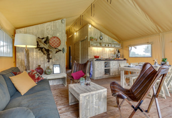 Indretning af luksuriøs safaritelte Forest Lodge på Sandberghe i Holland med træmøbler og hyggelig atmosfære.