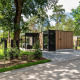 Moderno lodge Veluwe hoeve al Resort Veluwe nei Paesi Bassi, immerso nel verde e alberi rigogliosi.