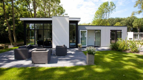 Cube Exclusif 4 lodge à Schoneveld, Pays-Bas, construction moderne, terrasse spacieuse et mobilier de jardin.
