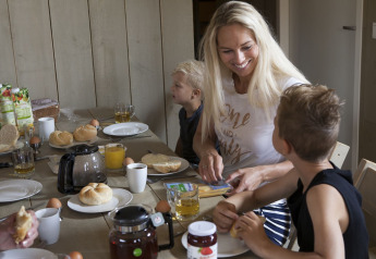 Una familia disfruta del desayuno junta en una tienda safari de lujo en Holiday park De Boshoek en los Países Bajos.