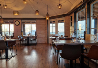 Indvendig udsigt over en hyggelig restaurant på husbåden Havenlodge Lelystad ved Marina Parcs i Holland.