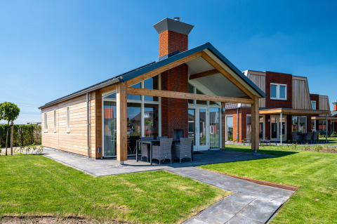 Modern Eneva disabled lodge at Tusken de Marren in the Netherlands with patio and green garden view.