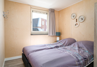 Accessible bedroom at Eneva disabled lodge, Tusken de Marren, Netherlands, with twin beds and window.