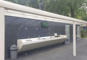 Outdoor washing area at Safari tent in Holiday Park Bonte Vlucht, Netherlands, with sinks and bins visible.