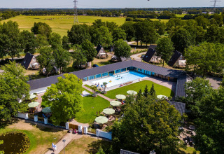 Aerial view of the Wellness Lodge XL at Hof van Salland, Netherlands, featuring a pool and greenery.