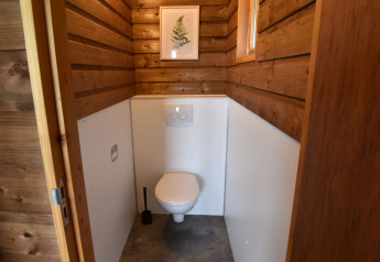 Photo of a modern toilet with wooden walls inside a cabin at Camping de Koeksebelt in the Netherlands.