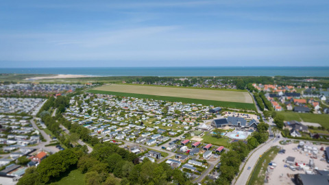 Vista aérea de Camping Zonneweelde en los Países Bajos con tiny houses y Beach Loft cerca del mar.
