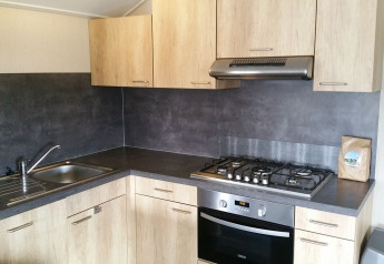 Modern kitchen of the Group lodge at Holiday park Eigen Wijze, Netherlands, featuring stove and oven.