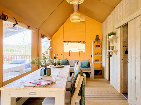Interior of Ranger Lodge safari tent at Recreation Park Den Blanken, Netherlands, with cozy wooden furnishings.