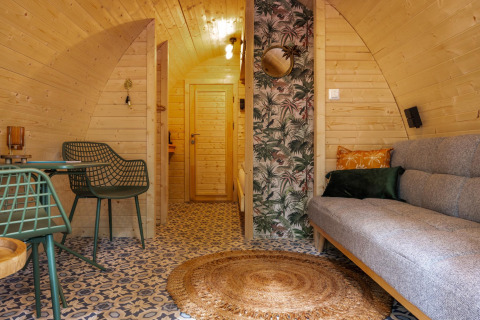 Interior of Boshuys Ultra Wellness tiny house at Buitengoed Ruysbos in the Netherlands with wood and cozy decor.